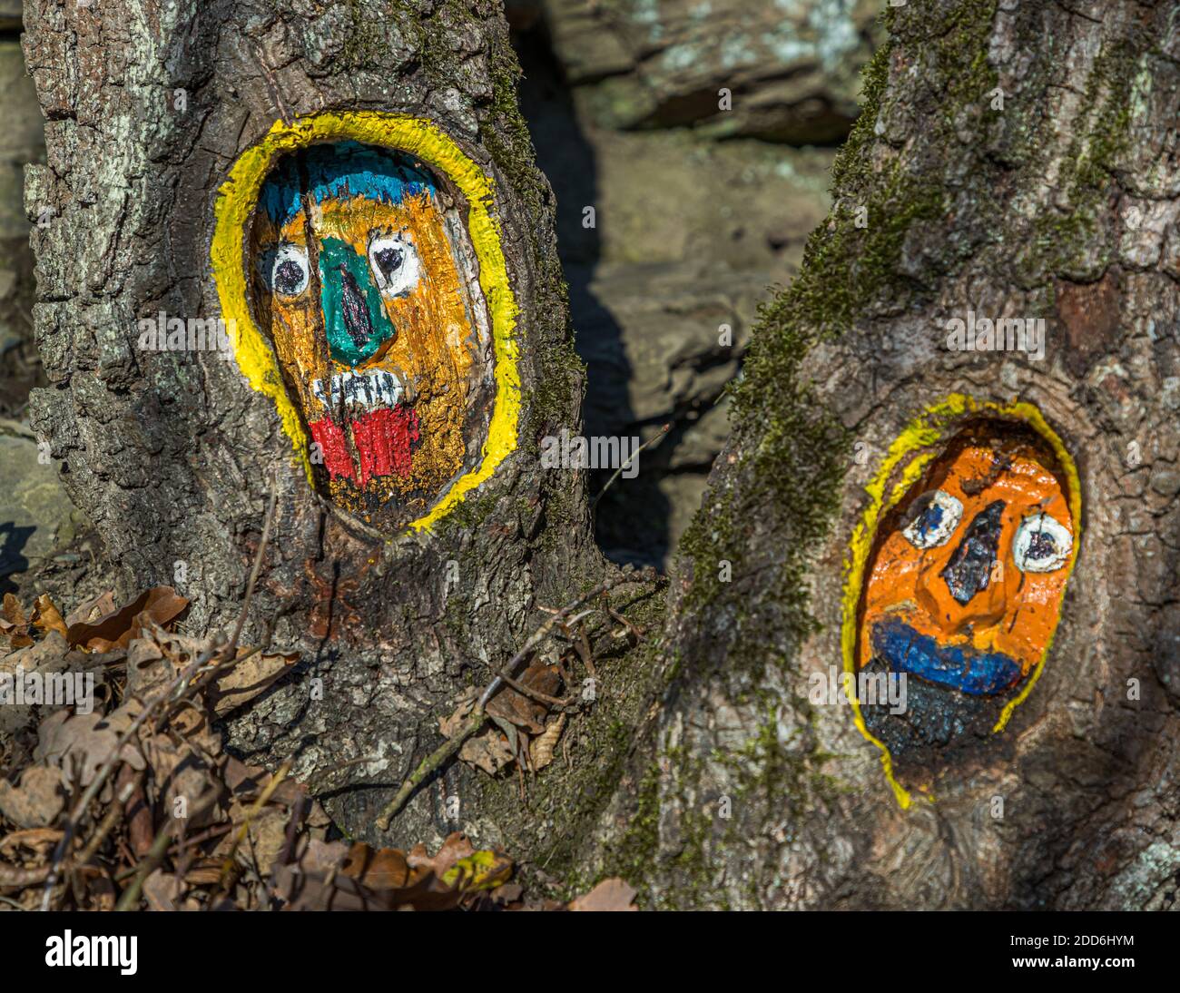 Colorful painted tree faces near Altenahr, Germany Stock Photo