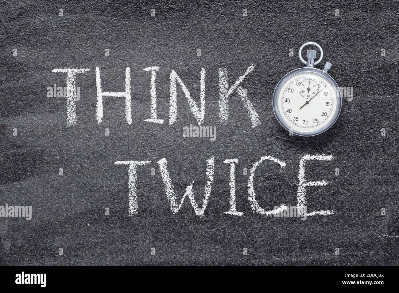 think twice phrase written on chalkboard with vintage precise stopwatch Stock Photo