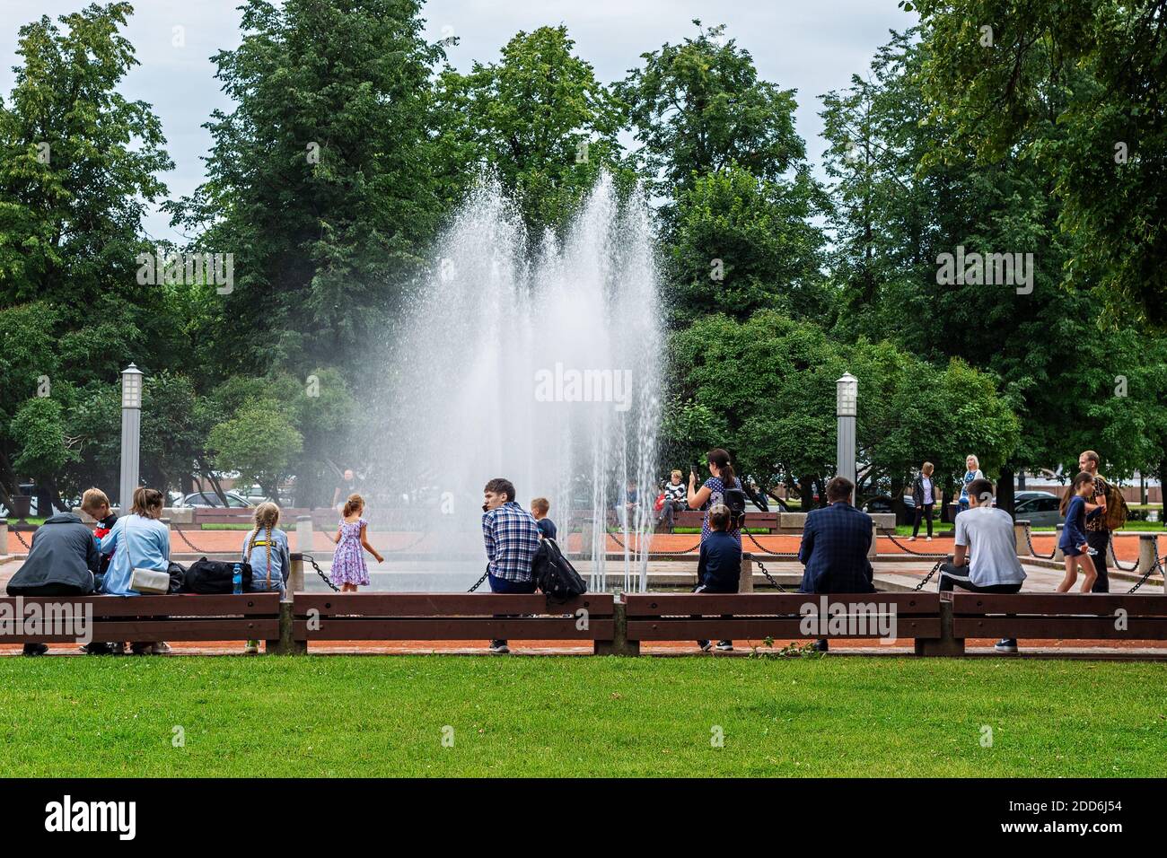 Saint Petersburg, Russia, August 3: Tourists and townspeople rest near the fountain in the city square on a warm summer day in St. Petersburg, August Stock Photo