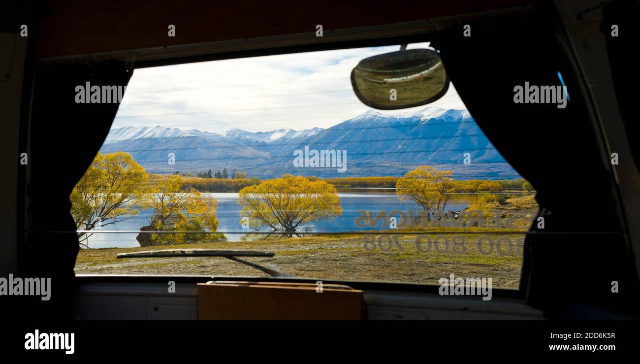Panoramic Photoof the View From Inside a Campervan of Snow Capped Mountains and Autumn Trees at Lake Alexandrina, South Island, New Zealand Stock Photo