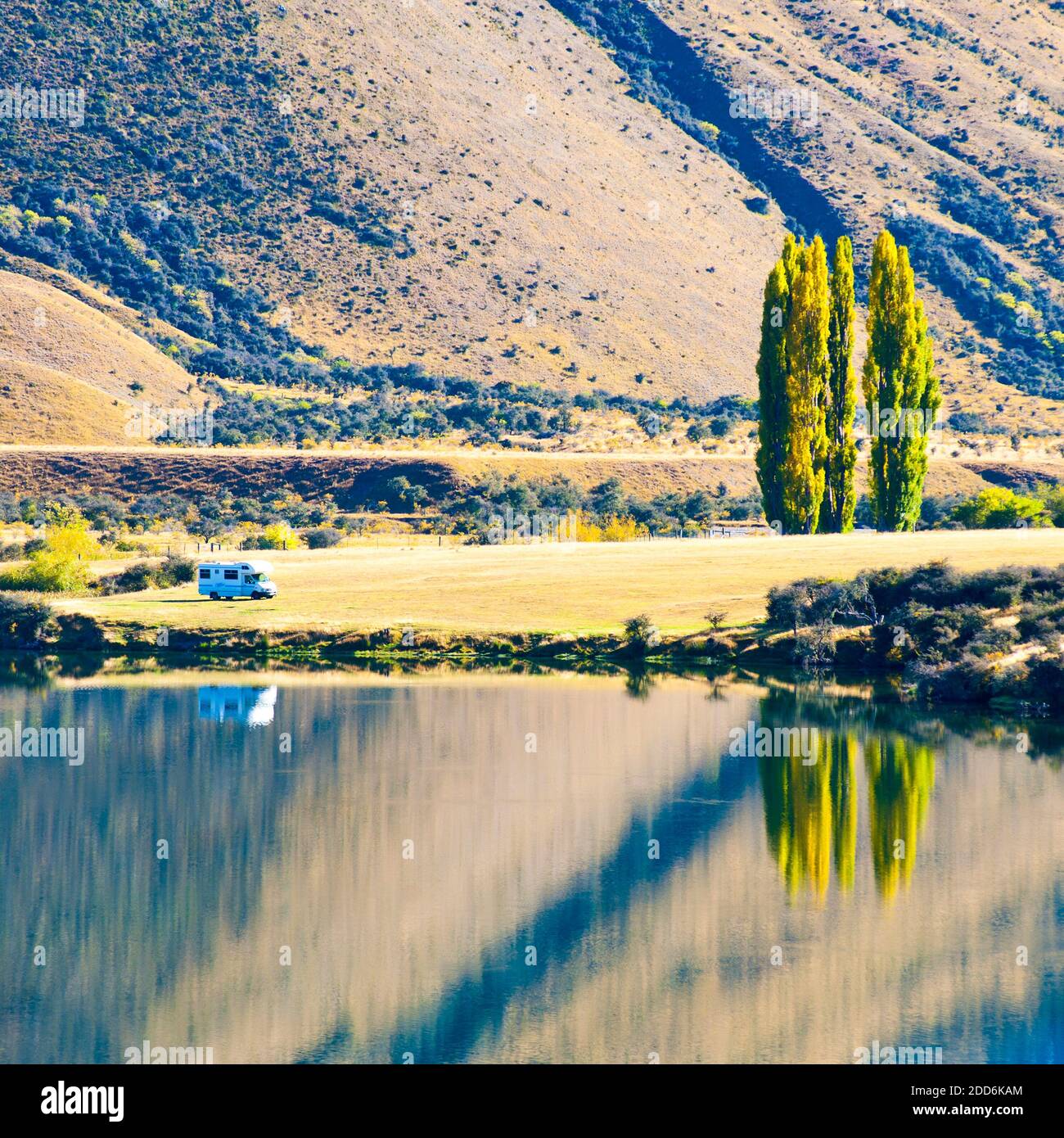 Caravan Parked at an Autumnal Lake Moke DOC Campsite, Queenstown, South Island, New Zealand Stock Photo