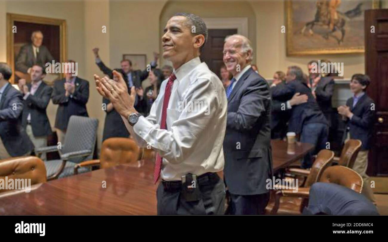 BARACK OBAMA, US President with Vice President Joe Biden and senior staff applaud the passing of the healthcare reform bill from the Roosevelt Room of thwe White House,21 March,2010. Photo: Pete Souza,White House official. Stock Photo