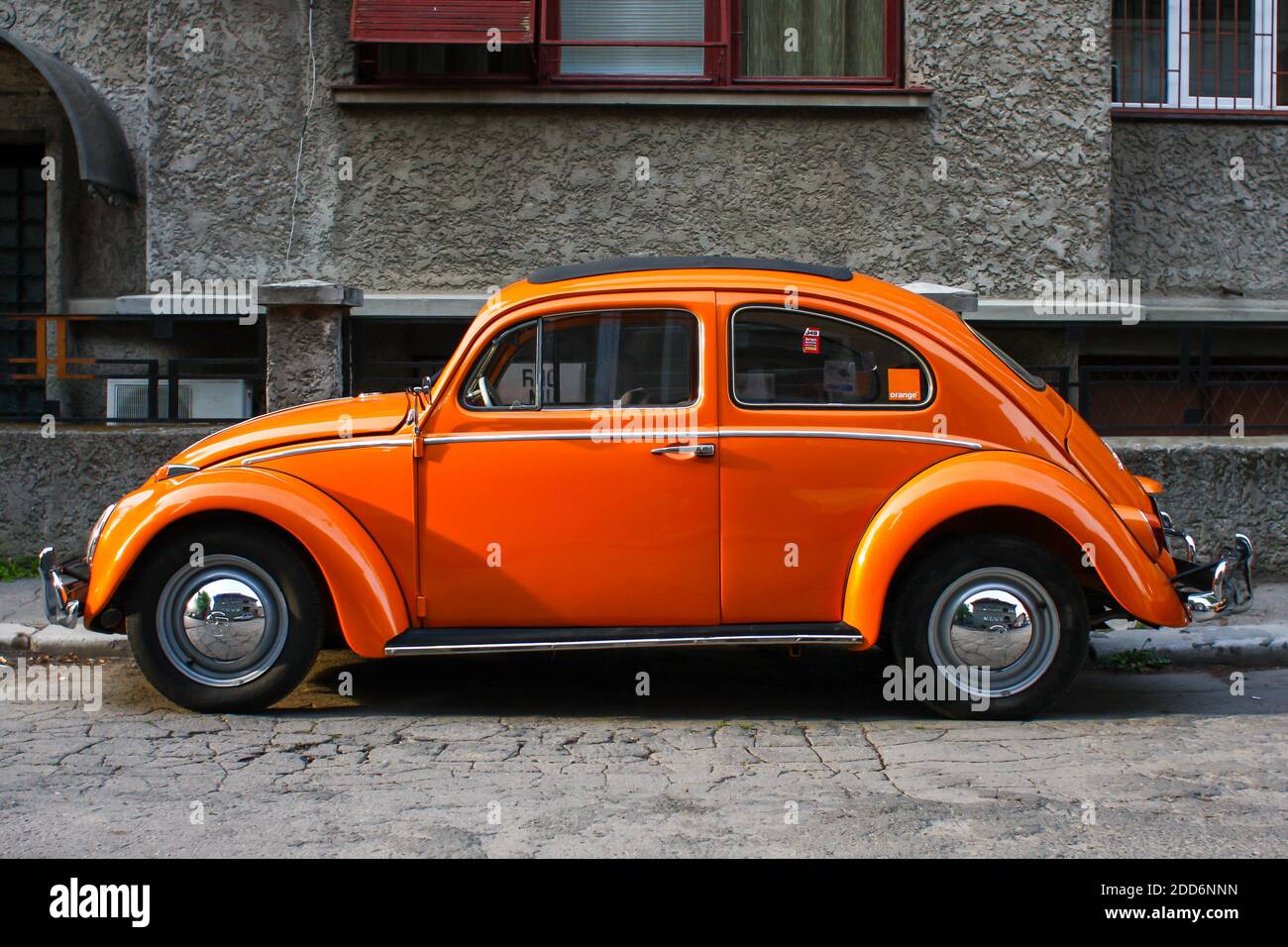 Bucharest, Romania - April 20, 2009: Orange vintage Volkswagen Beetle car on a street in Bucharest. Stock Photo