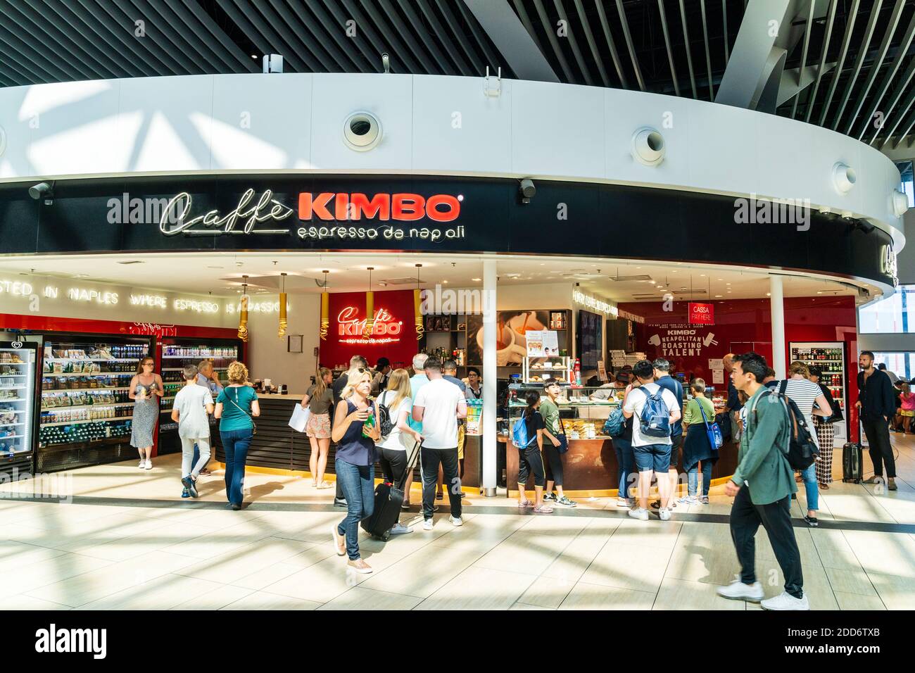 Interior of the E2nd floor of the departure area of Leonardo da Vinci - Fiumicino Rome airport, people at the main counter of the Caffe Kimbo eatery. Stock Photo
