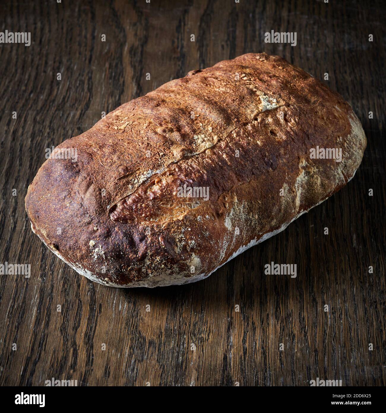 freshly baked bread on wooden table Stock Photo