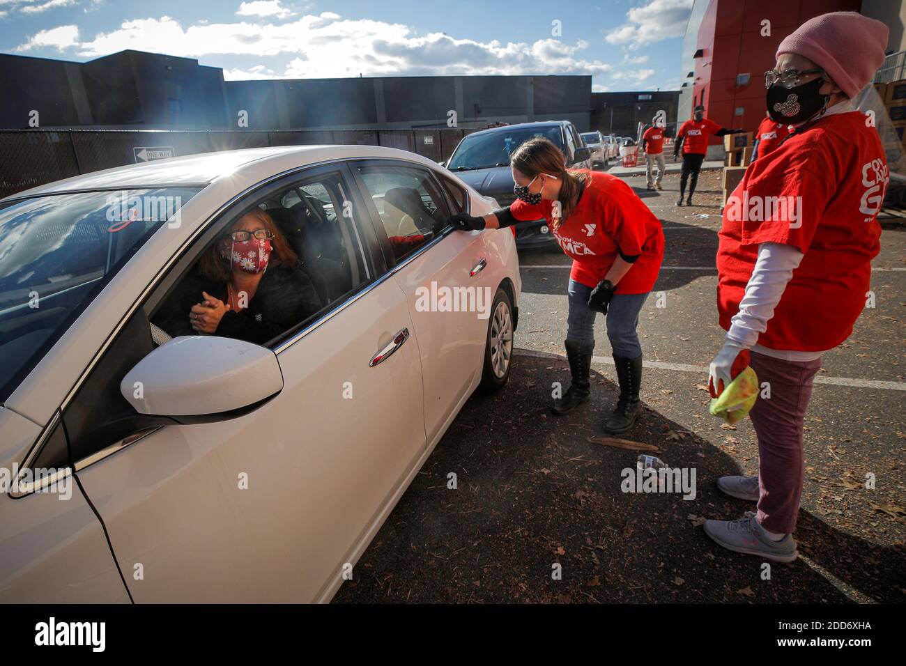 Volunteers greet people during the Meadowlands Area YMCA and the Community  Food Bank of New Jersey food drive ahead of the Thanksgiving holiday,  during the COVID-19 pandemic, in East Rutherford, New Jersey,