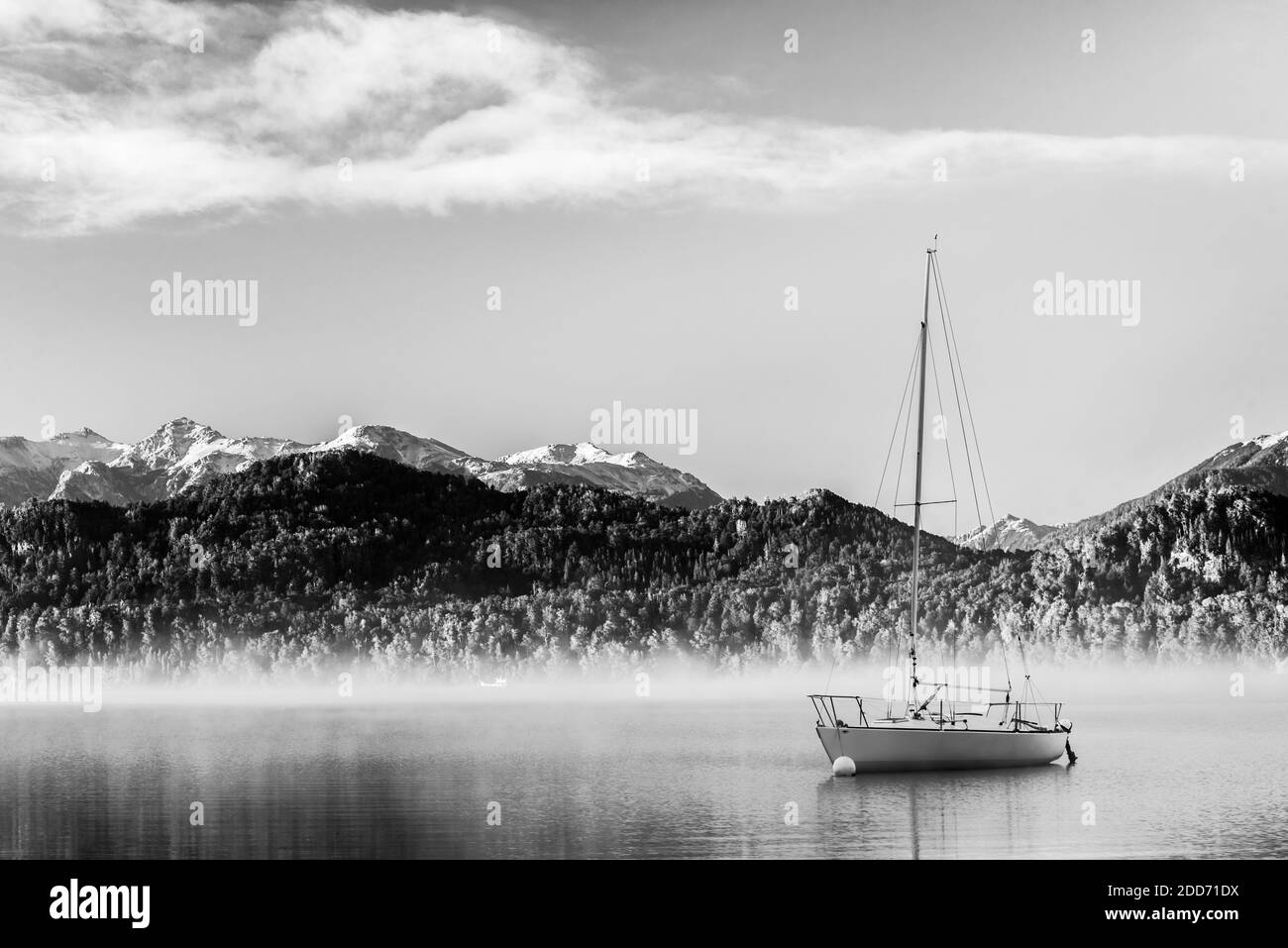 Sailing boat on misty Lake Nahuel Huapi at sunrise, Villa la Angostura, Neuquen, Patagonia, Argentina, South America Stock Photo