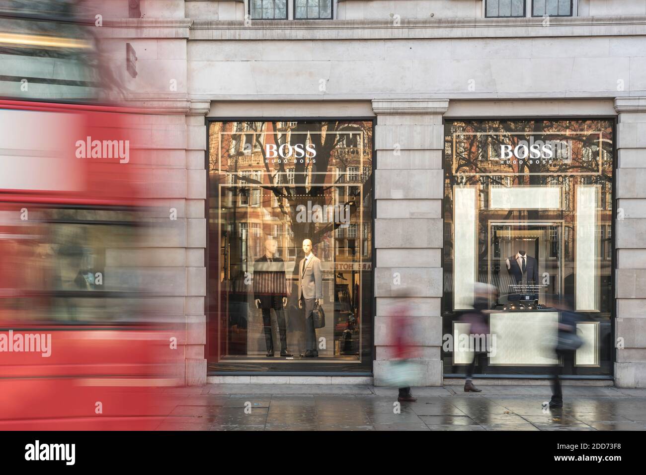 People shopping in Sloane Square, walking past the Hugo Boss shop, London, England Stock Photo