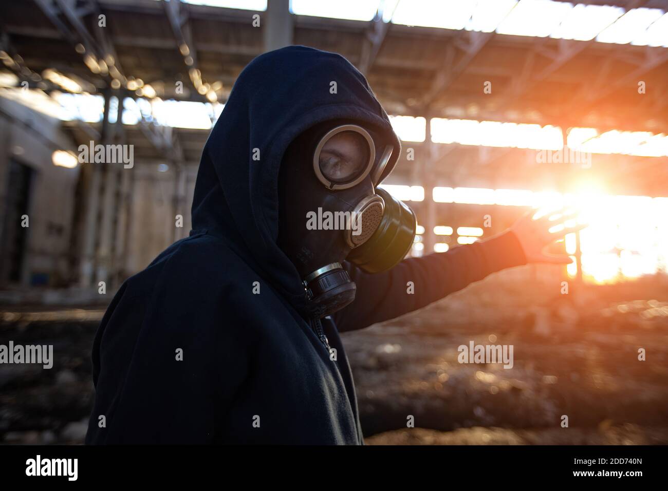 Person in gas mask in abandoned industrial building Stock Photo - Alamy