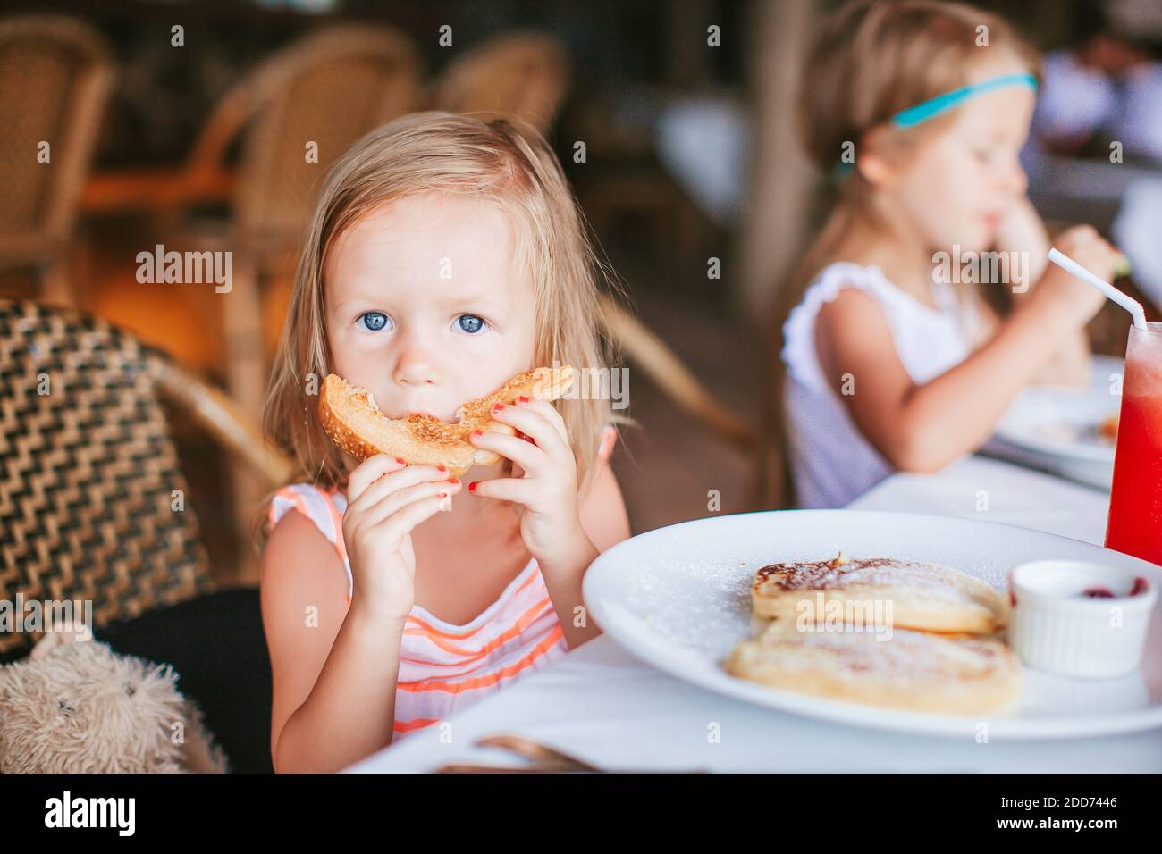 Breakfast Little Adorable little girl having breakfast at outdoor cafe Stock Photo - Alamy