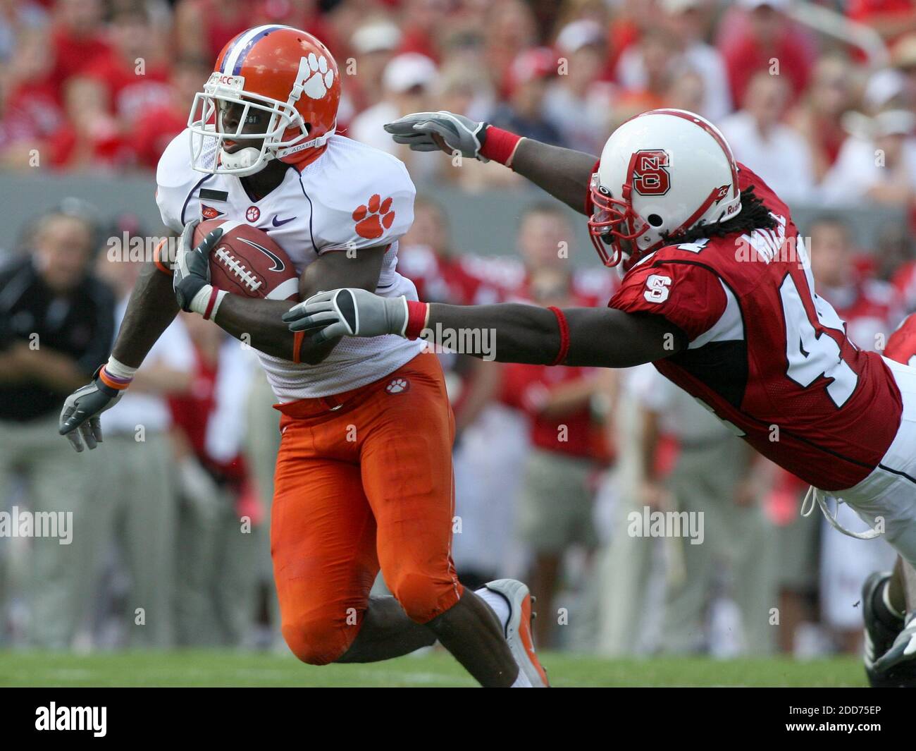 NO FILM, NO VIDEO, NO TV, NO DOCUMENTARY - Clemson's Jacoby Ford tries to evade the grasp of N.C. State's Ray Michel in the first half on Saturday, September 22, 2007, at Carter-Finley Stadium at Carter-Finley Stadium in Raleigh, NC, USA on September 22, 2007. The Tigers defeated the Wolfpack 42-20. Photo by Ethan Hyman/Raleigh News & Observer/MCT/Cameleon/ABACAPRESSS.COM Stock Photo