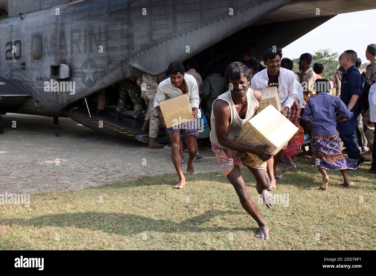 NO FILM, NO VIDEO, NO TV, NO DOCUMENTARY - Bangladeshi locals off-load food and supplies CH-53E Super Stallion from the 22nd Marine Expeditionary Unit Special Operations Capable, embarked aboard the amphibious assault ship USS Kearsarge in Rangabali, Bangladesh on December 1, 2007. Photo by Peter R. Miller/US Marine Corps/MCT/ABACAPRESS.COM Stock Photo