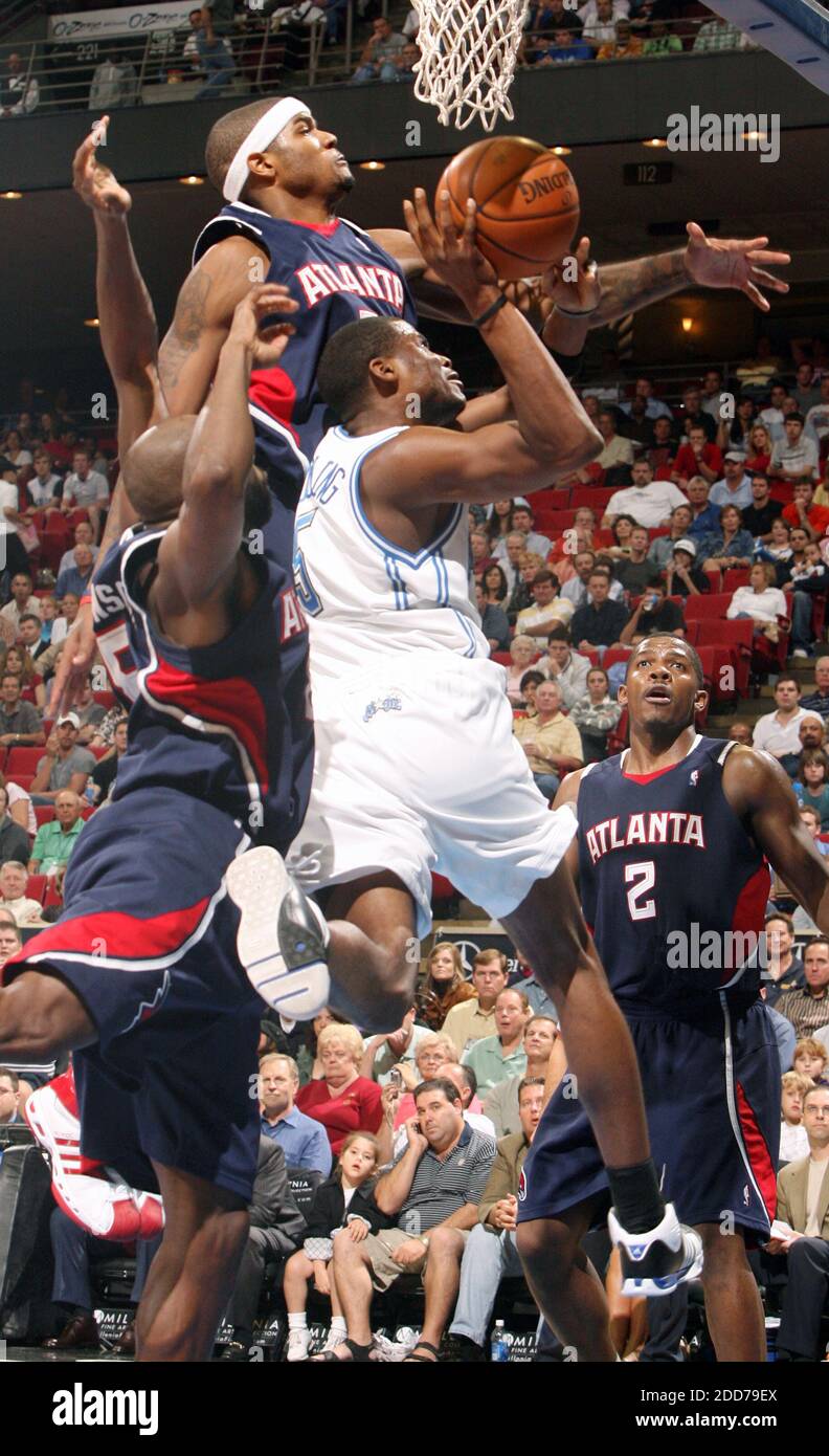 NO FILM, NO VIDEO, NO TV, NO DOCUMENTARY - Orlando Magic guard Keyon Dooling (5) drives to the basket in between Atlanta Hawks defenders Anthony Johnson (8), left, and Josh Smith (5), top, as Joe Johnson (2) looks on at Amway Arena in Orlando, FL, USA on December 10, 2007.The Hawks defeated the Magic, 98-87 Photo by Gary W. Green/MCT/ABACAPRESS.COM Stock Photo