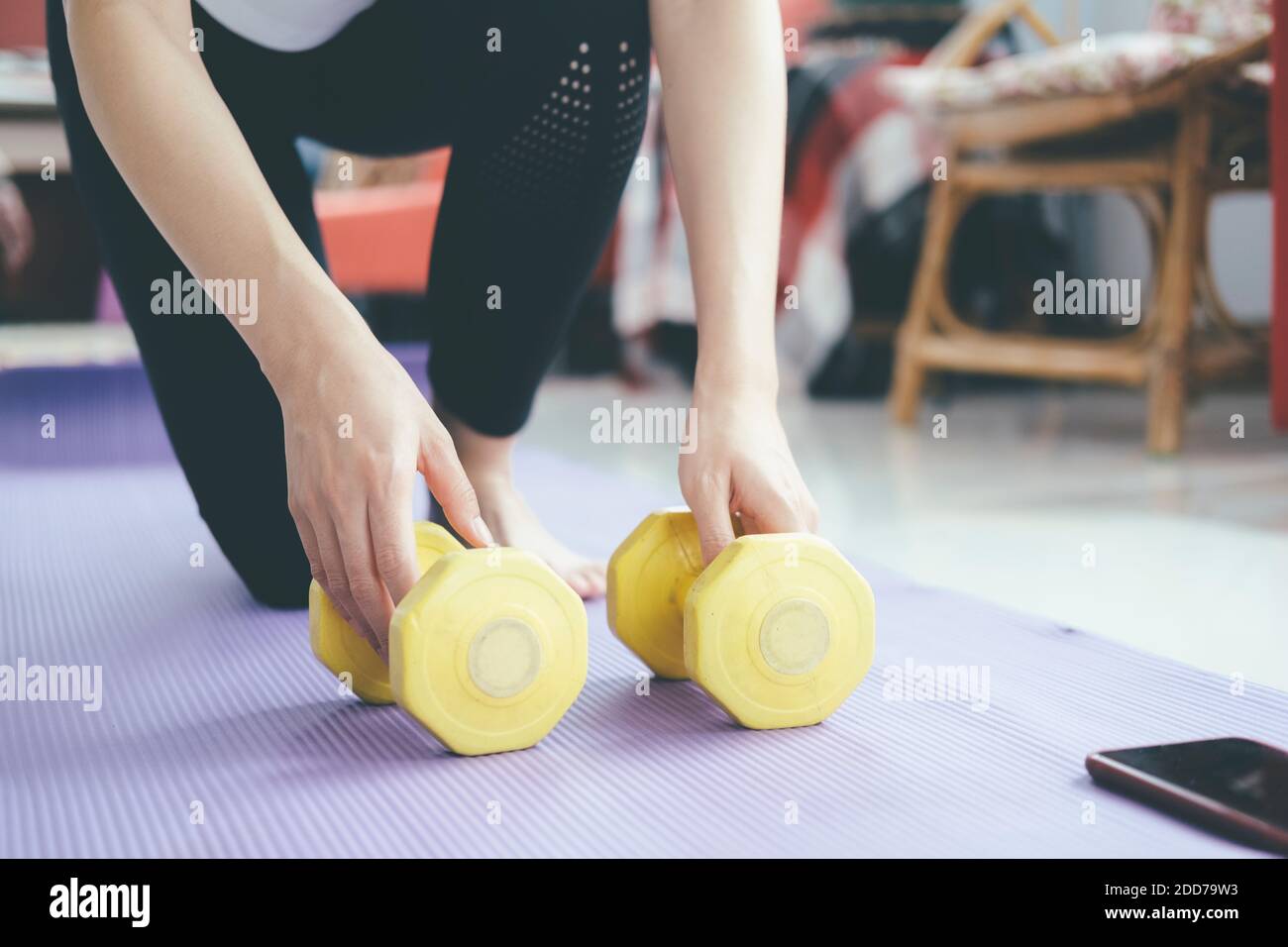 Closeup woman hands holding dumbell. The concept of a healthy lifestyle and fitness. Stock Photo