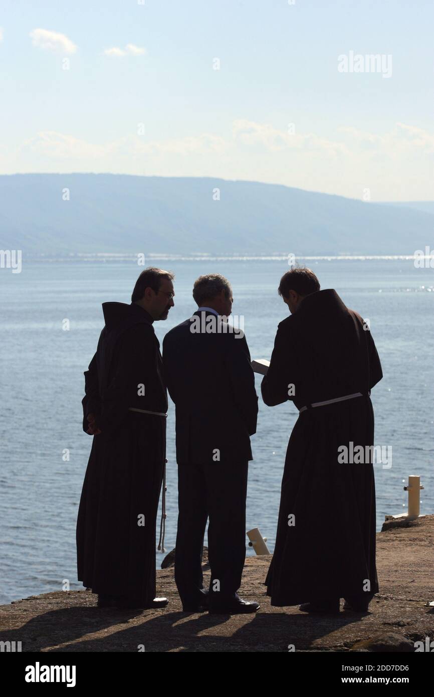 NO FILM, NO VIDEO, NO TV, NO DOCUMENTARY - U.S. President George W. Bush (center), flanked by Franciscan priests, looks at the Sea of Galilee in the ancient village of Capernaum, Israel on January 11, 2008. Bush visited the Sea of Galilee today on a pilgrimage to some of Christianity's most sacred sites at the end of a landmark peace mission. Capernaum is close to where Jesus is said to have miraculously fed 5,000 people with a few loaves and fish and where he anointed Peter the rock on which he would build his new church. Photo by Alon Ron/FLASH 90/MCT/ABACAPRESS.COM Stock Photo