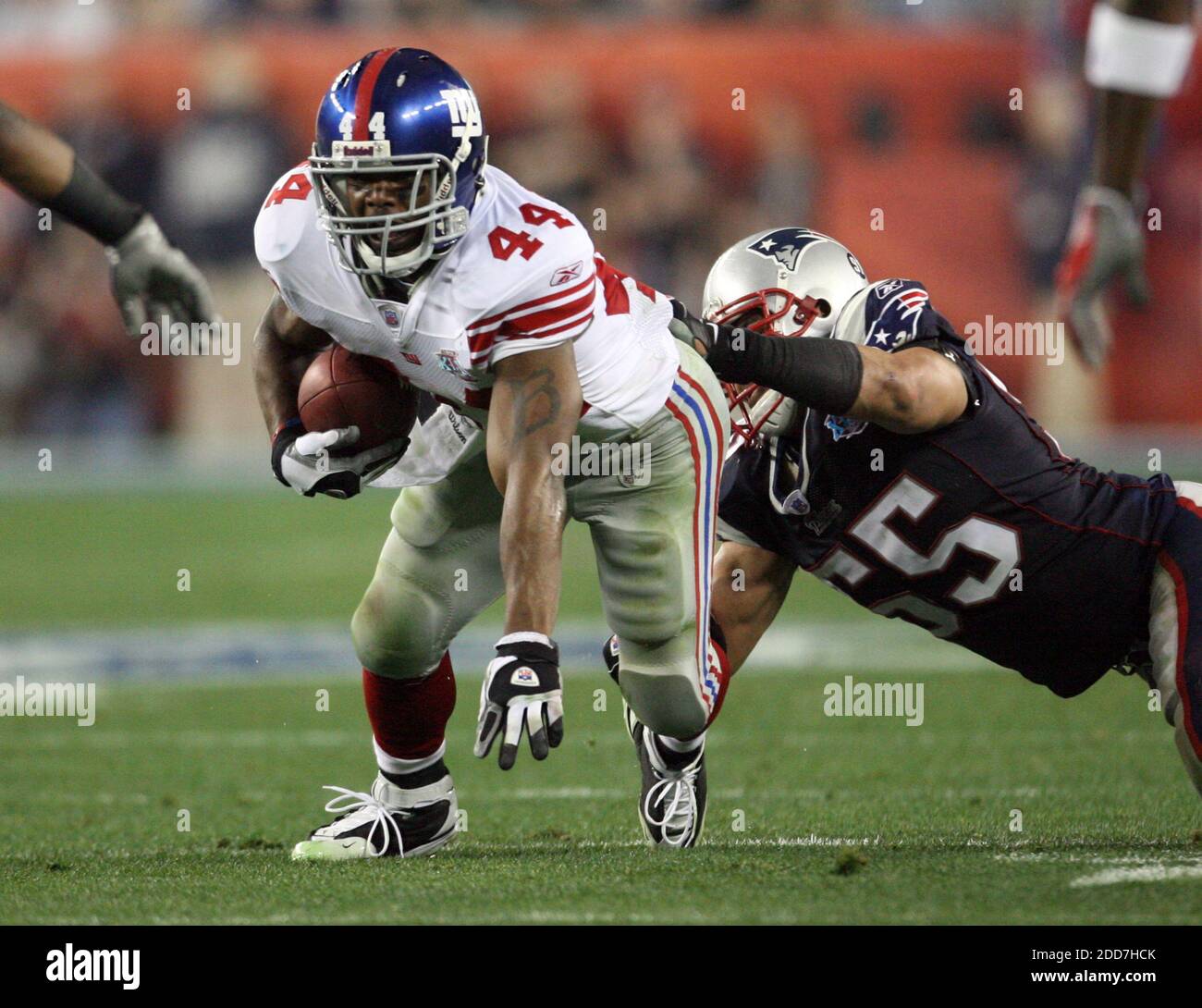 The New York Giants' Ahmad Bradshaw (44) makes a gain against the New England Patriots' Junior Seau (55) in the first half of Super Bowl XLII at University of Phoenix Stadium in Glendale, AZ, USA on February 3, 2008.  The NY Giants won 17-14. Photo by Gary W. Green/MCT/Cameleon/ABACAPRESS.COM Stock Photo