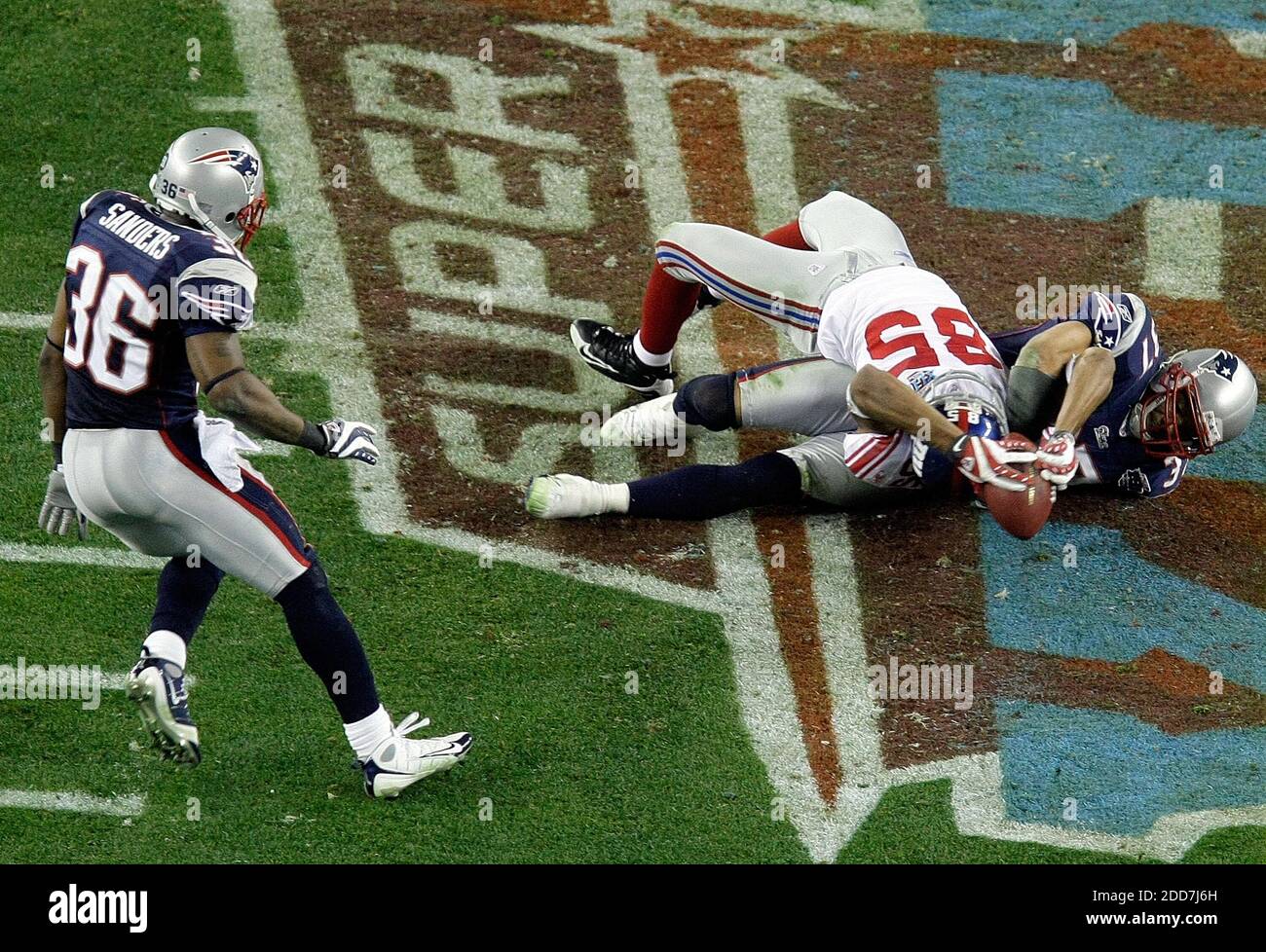 New York Giants receiver David Tyree (85) hauls in a long pass against the New England Patriots' Rodney Harrison (37) on the game-winning drive in a 17-14 victory over the New England Patriots in the second half of Super Bowl XLII at University of Phoenix Stadium in Glendale, AZ, USA on February 3, 2008.  The NY Giants won 17-14. Photo by Mark Cornelison/MCT/Cameleon/ABACAPRESS.COM *** Local Caption *** Stock Photo