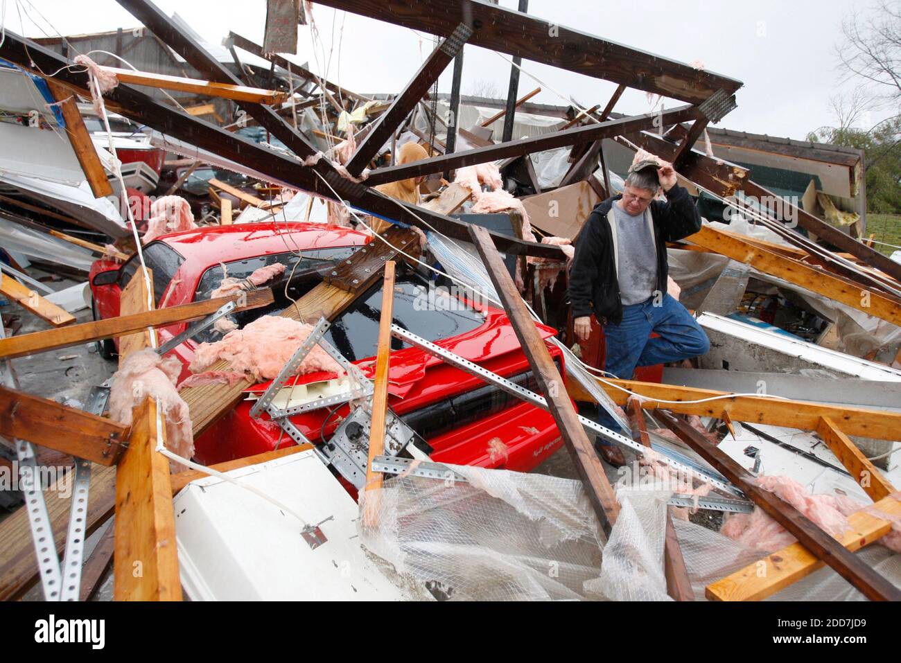 Don Chapman, with the help of Richard Jones in background, started the process of cleaning up his shop in Harrodsburg, Kentucky, Wednesday, February 6, 2008. Early morning storms caused heavy damage throughout Central Kentucky with Mercer County being particularly hard hit. His shop housed a 1991 Firebird, a 1949 Mercury, a 1976 Jeep, a 1971 GMC Sprint, a large boat, and numerous tools. Photo by Charles Bertram/Lexington Herald-Leader/MCT/ABACAPRESS.COM Stock Photo