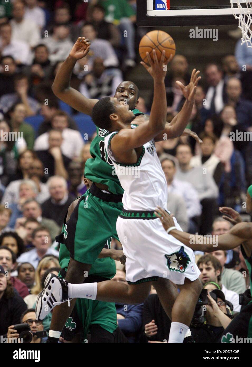NO FILM, NO VIDEO, NO TV, NO DOCUMENTARY - The Minnesota Timberwolves' Ryan  Gomes gets a shot off over the defense of the Boston Celtics' Kendrick  Perkins in the first quarter at