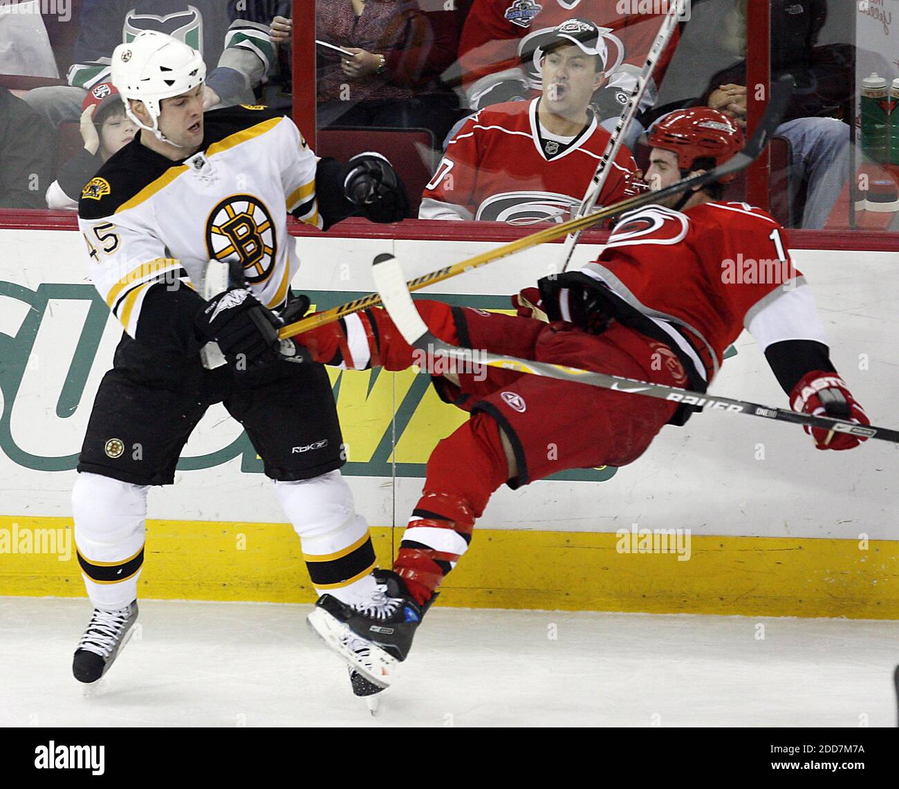 The Carolina Hurricanes' Andrew Ladd (16) gets upended by a check from the Boston Bruins' Mark Stuart (45) during second period action at the RBC Center in Raleigh, NC, USA on February 19, 2008. The Bruins defeated the Hurricanes in overtime, 3-2. Photo by Chris Seward/Raleigh News & Observer/MCT/Cameleon/ABACAPRESS.COM Stock Photo