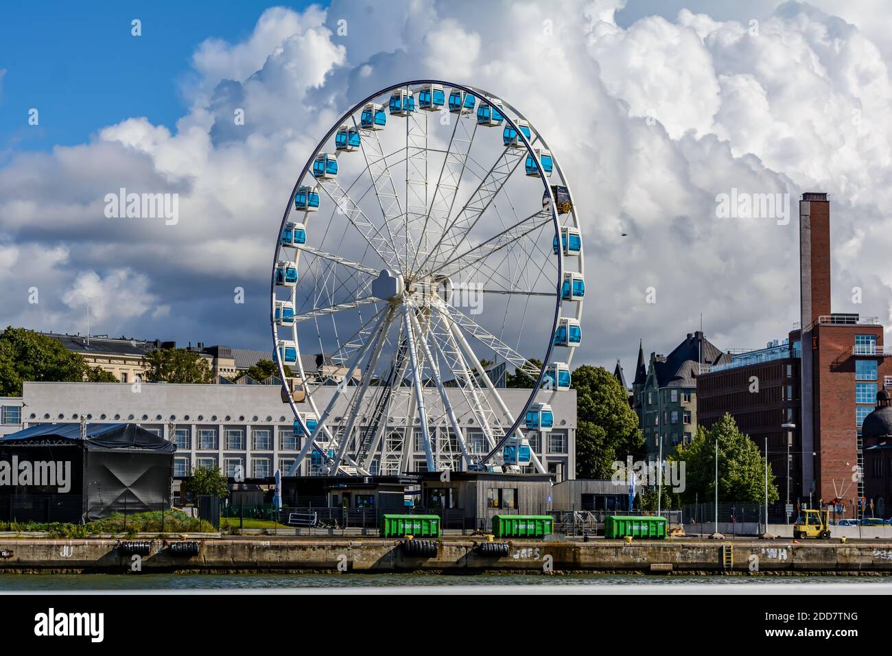 Tall Ferris wheel called Helsinki SkyWheel rising above the harbour Stock Photo
