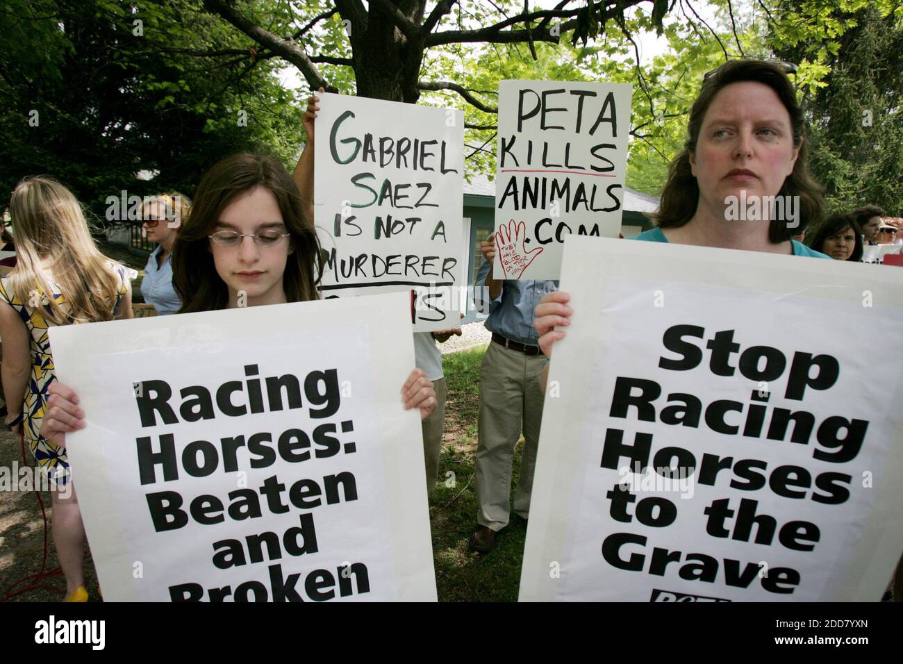 NO FILM, NO VIDEO, NO TV, NO DOCUMENTARY - Abby Greenstein, left, and Kelly Greenstein from Lexington, Kentucky, hold signs protesting the racing industry, while horse industry supporters hold their own signs, at the Kentucky Horse Racing Authority's headquarters in Lexington, KY, USA on May 6, 2008. PETA has urged the suspension of jockey Gabriel Saez for what it viewed as excessive whipping of Eight Belles during the Kentucky Derby. Photo by Jenn Ackerman/Lexington Herald-Leader/MCT/ABACAPRESS.COM Stock Photo