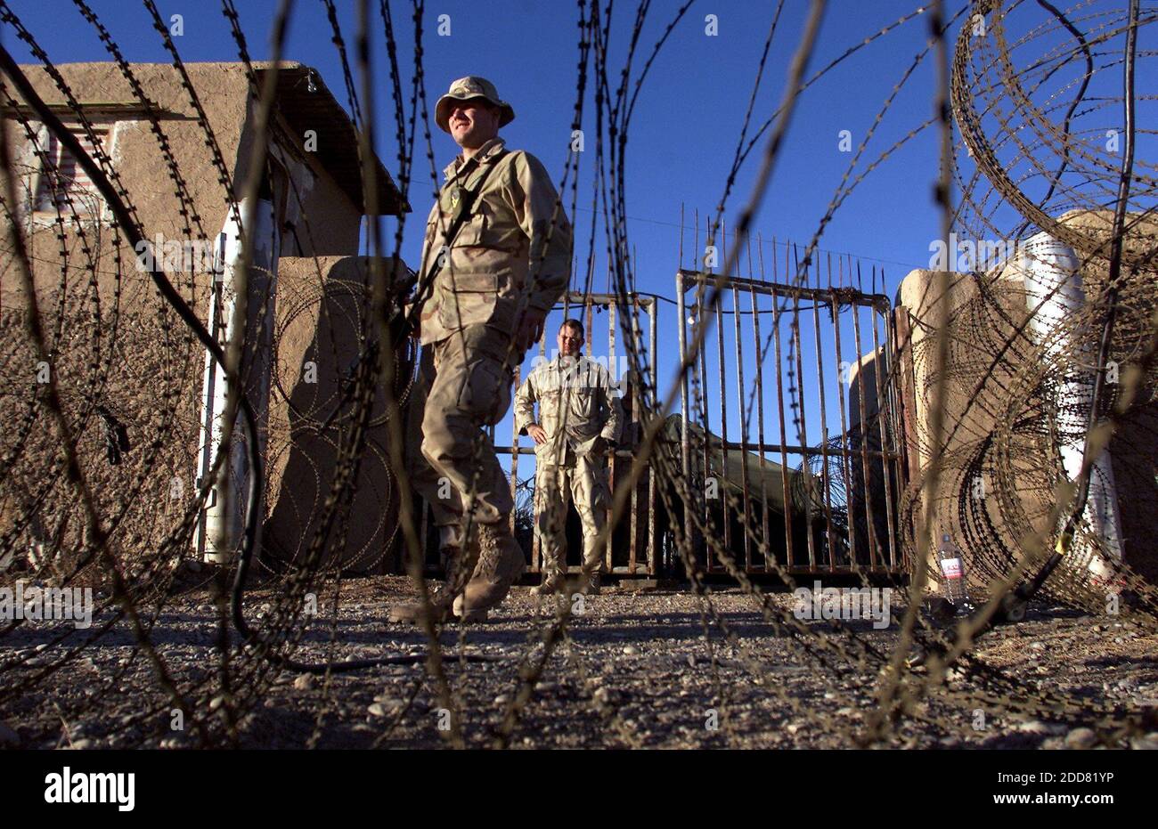 NO FILM, NO VIDEO, NO TV, NO DOCUMENTARY - Members of the 26th Marine Expeditionary unit stand guard at the entrance of the newly constructed battlefield detainee facility at the Kandahar International Airport, in Kandahar, Afghanistan on December 18, 2001. Although the public outcry in the United States and abroad has focused mainly on detainee abuse at the U.S. naval base in Guantanamo Bay, Cuba, and at the Abu Ghraib prison in Iraq, sadistic violence first appeared at Bagram and at a similar U.S. internment camp at Kandahar airfield in southern Afghanistan. Photo by Tom Pennington/Fort Wort Stock Photo