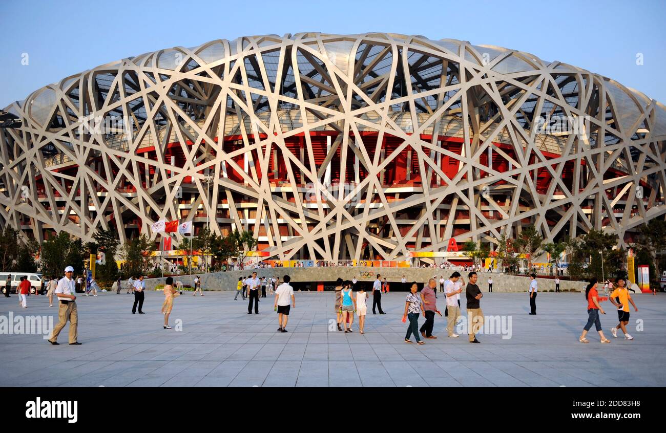 NO FILM, NO VIDEO, NO TV, NO DOCUMENTARY - People walk in front of the National Stadium, called the Bird's Nest, which on Friday will host the opening ceremony of the the XXIX Olympiad in Beijing, China on August 5, 2008. Photo by David Eulitt/Kansas City Star/MCT/Camelon/ABACAPRESS.COM Stock Photo