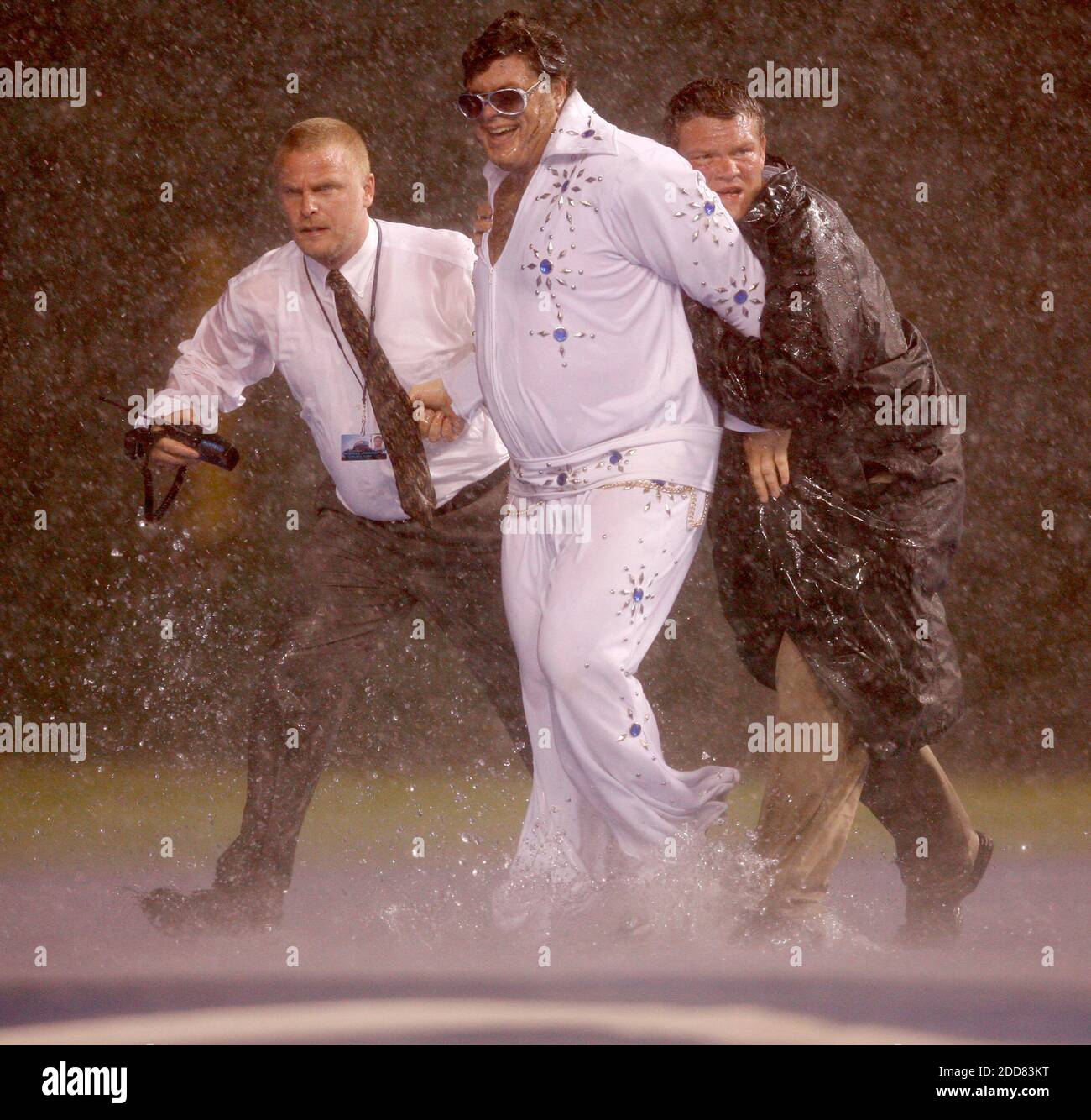 Chicago Cubs fans are arrested after sliding on the tarp during a rain delay in the Cubs game against the Houston Astros at Wrigley Field in Chicago, Illinois, on Monday August 4, 2008. Photo by Nuccio DiNuzzo/Chicago Tribune/MCT/Cameleon/ABACAPRESS.COM Stock Photo