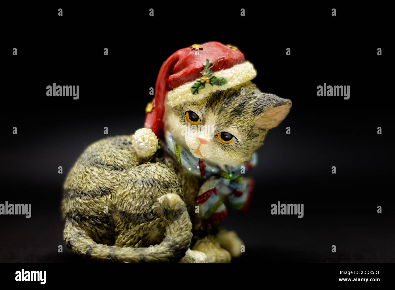 Ceramic cat with a cute Christmas hat. Stock Photo