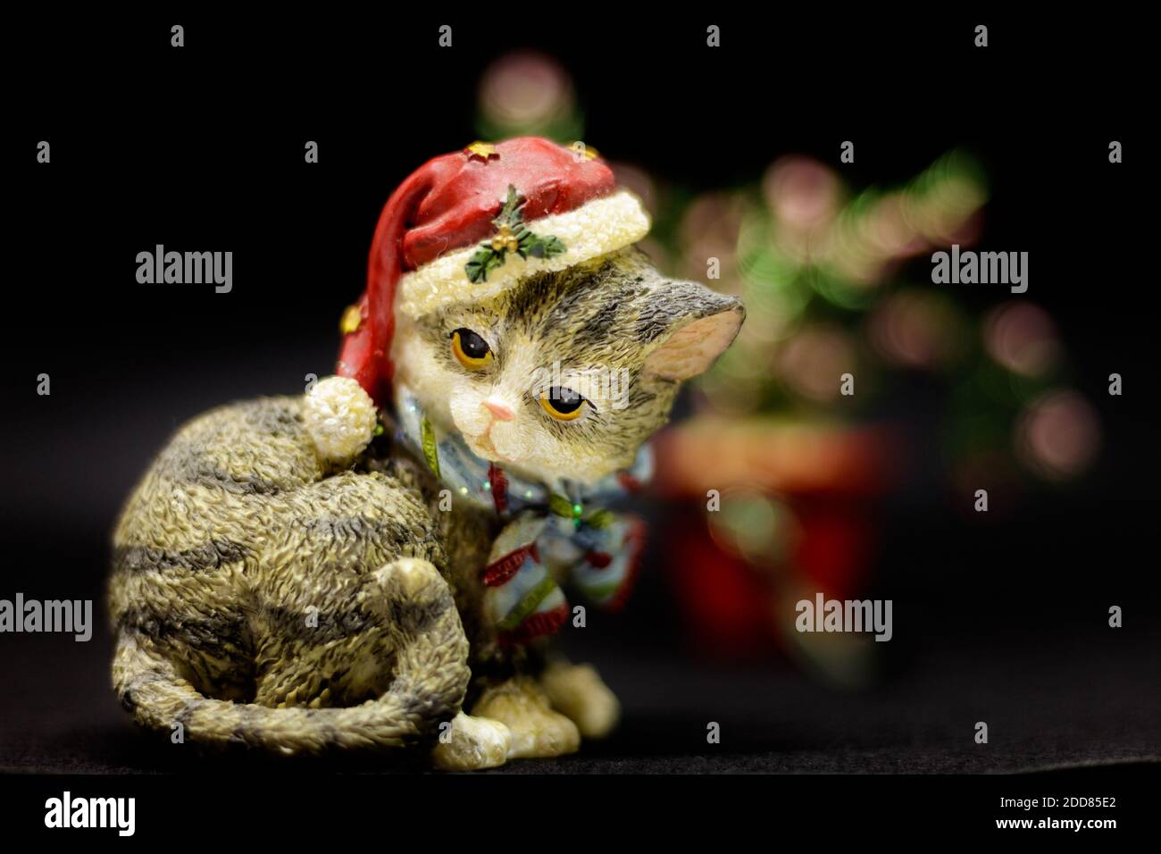 Ceramic cat with a cute Christmas hat. Stock Photo