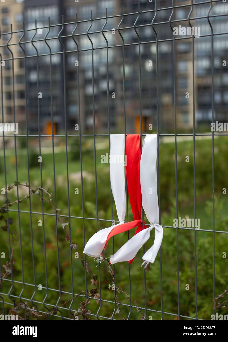 White-red-white ribbons on the fence. White-red-white flag. Stock Photo