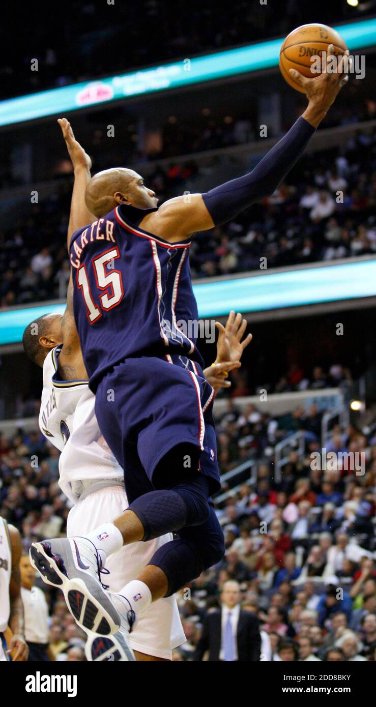 NO FILM NO VIDEO NO TV NO DOCUMENTARY New Jersey Nets forward Vince Carter 15 lays up the ball over Washington Wizards defender Caron Bulter during opening night action at the