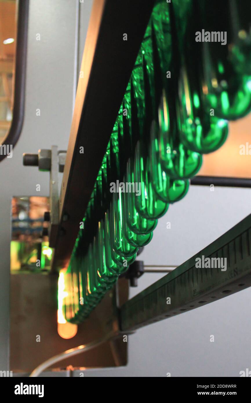 Green pet plastic bottle preforms on a conveyer. Concept of bottled
