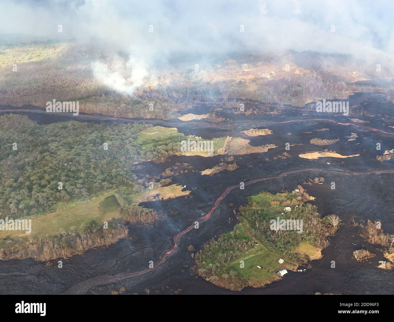 Handout photo taken on May 22, 2018 of Kilauea Volcano — Overflight of Lower East Rift Zone. View during an early morning overflight of KÄ«lauea Volcano's lower East Rift Zone. Two fissures (not pictured) are sending lava down two channels that merge near the coast. Photo by usgs via ABACAPRESS.COM Stock Photo