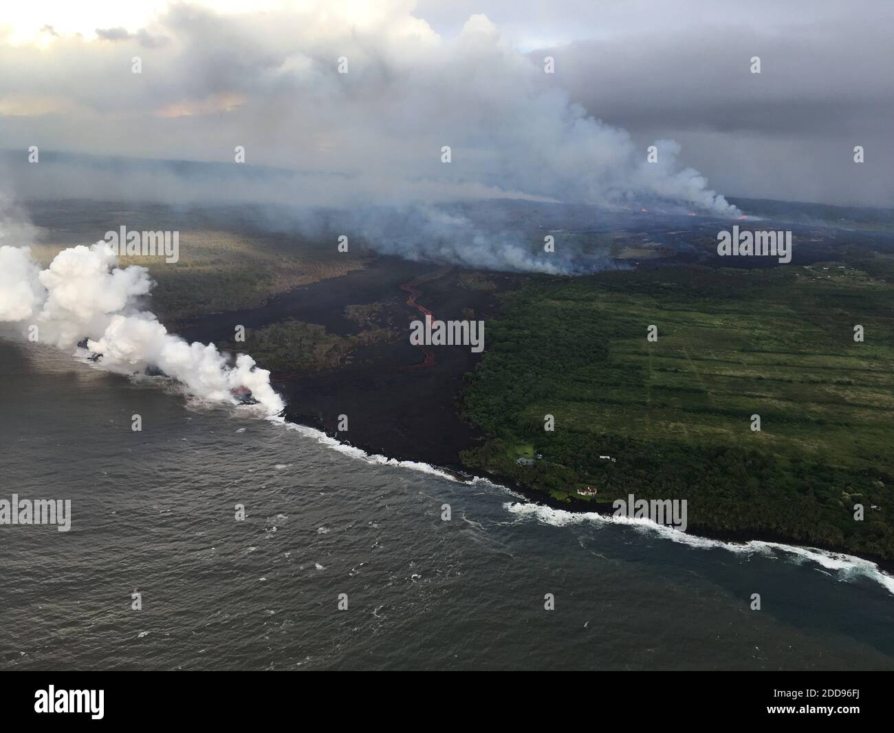 Handout photo taken on May 22, 2018 of Kilauea Volcano — Ocean Entry. The fissure complex, pictured in the upper right, continues to feed a meandering lava flow (in the center). Lava in the easternmost lobe is entering the ocean (white plume). Photo by usgs via ABACAPRESS.COM Stock Photo