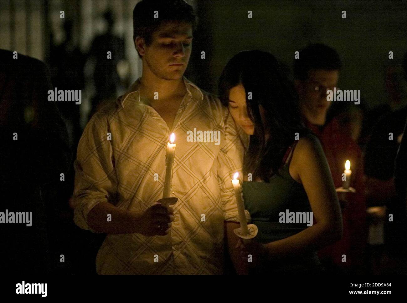 NO FILM, NO VIDEO, NO TV, NO DOCUMENTARY - Students Andrew Williams, 19,  left, and Peggy Liu, 20, stand together during a candlelight vigil at Yale's  campus in New Haven, Connecticut, September