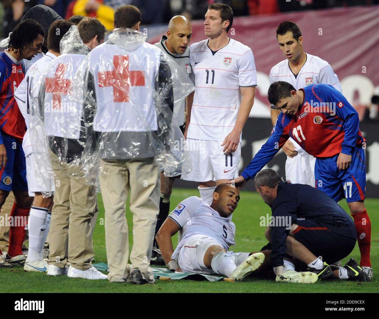 NO FILM, NO VIDEO, NO TV, NO DOCUMENTARY - USA defender Oguchi Onyewu (5) sits on the pitch surrounded by teammates, members of Costa Rica team and first aid officials, after suffering a torn tendon in his left during World Cup qualifier Soccer Match, USA vs Costa Rica at RFK Stadium in Washington, DC, USA on October 14, 2009. The match ended in a 2-2 draw.Photo by Chuck Myers/MCT/ABACAPRESS.COM Stock Photo