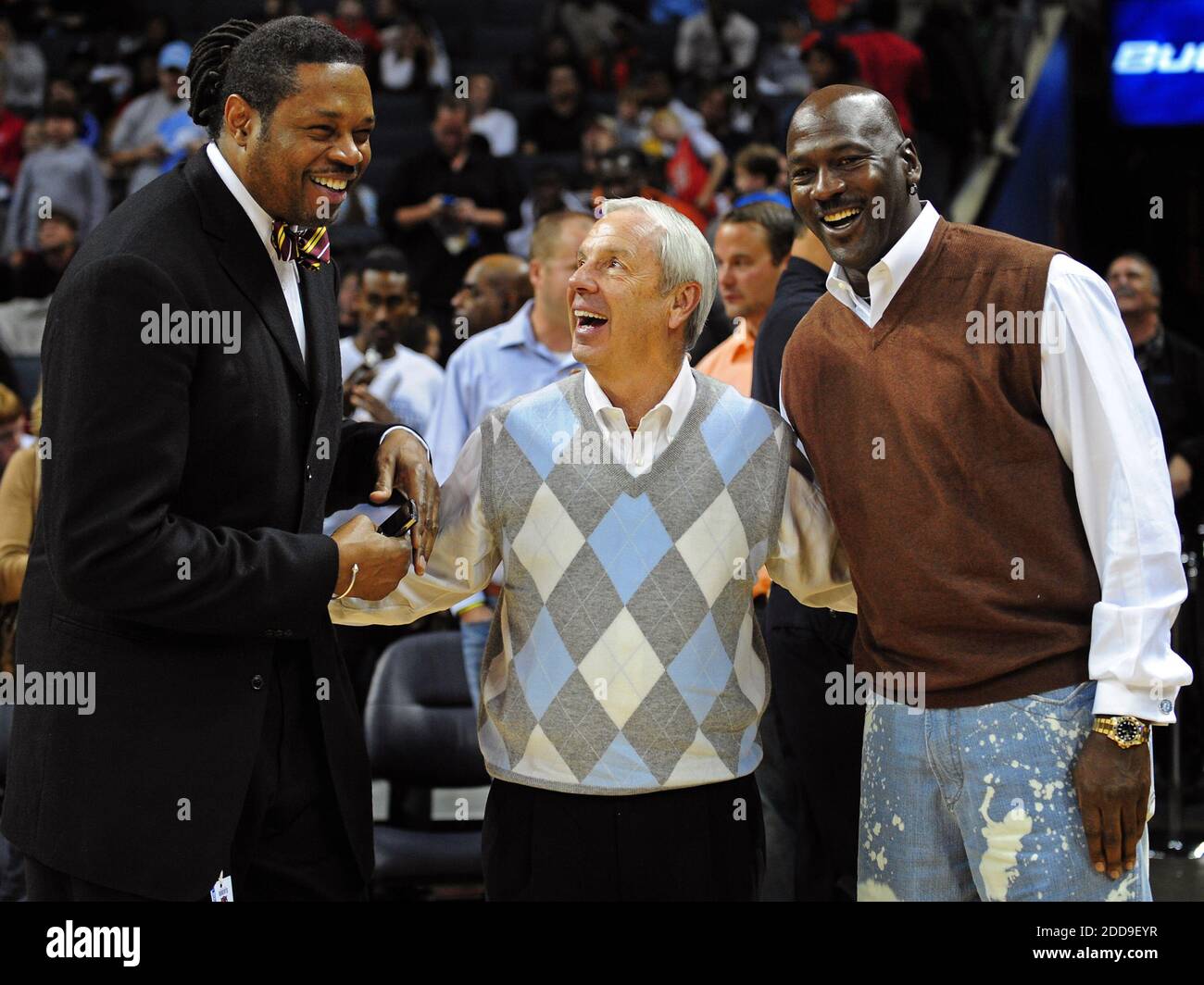 NO FILM, NO VIDEO, NO TV, NO DOCUMENTARY - Former NBA player Sam Perkins, North Carolina head coach Roy Williams and former NBA great and current Charlotte Bobcats part owner Michael Jordan talk during half time as the Charlotte Bobcats faced the Indiana Pacers at Time Warner Cable Arena in Charlotte, NC, USA on November 22, 2009. The Bobcats defeated the Pacers 104-88. Photo by Jeff Siner/Charlotte Observer/MCT/Cameleon/ABACAPRESS.COM Stock Photo