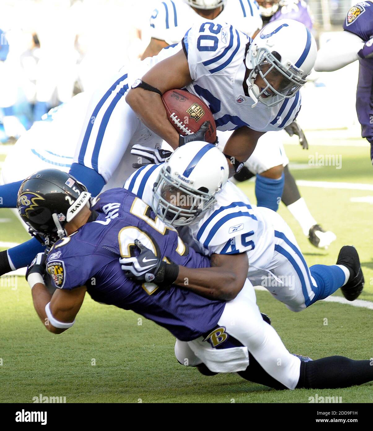 NO FILM, NO VIDEO, NO TV, NO DOCUMENTARY - Indianapolis Colts punt returner T.J. Rushing (20) hurdles over De'von Hall (45), who drills Baltimore Ravens cornerback Chris Carr in the first quarter of play in Baltimore, MD, USA on November 22, 2009. The Colts defeated the Ravens 17-15. Photo by Karl Merton Ferron/Baltimore Sun/MCT/Cameleon/ABACAPRESS/COM Stock Photo