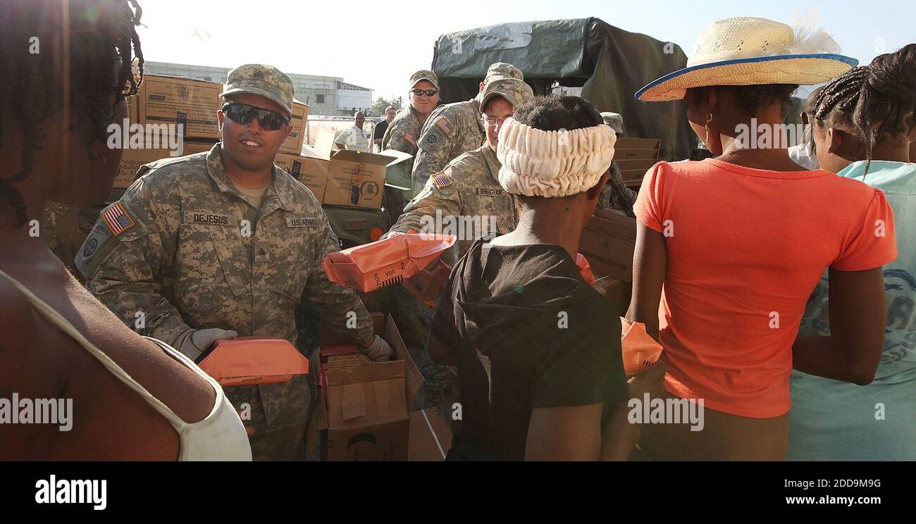 No Film No Video No Tv No Documentary U S Army Sgt Eric Dejesus Left And Ssgt Brennan Renghan Hand Out Meals At A Food Distribution To The People In Cite Soleil