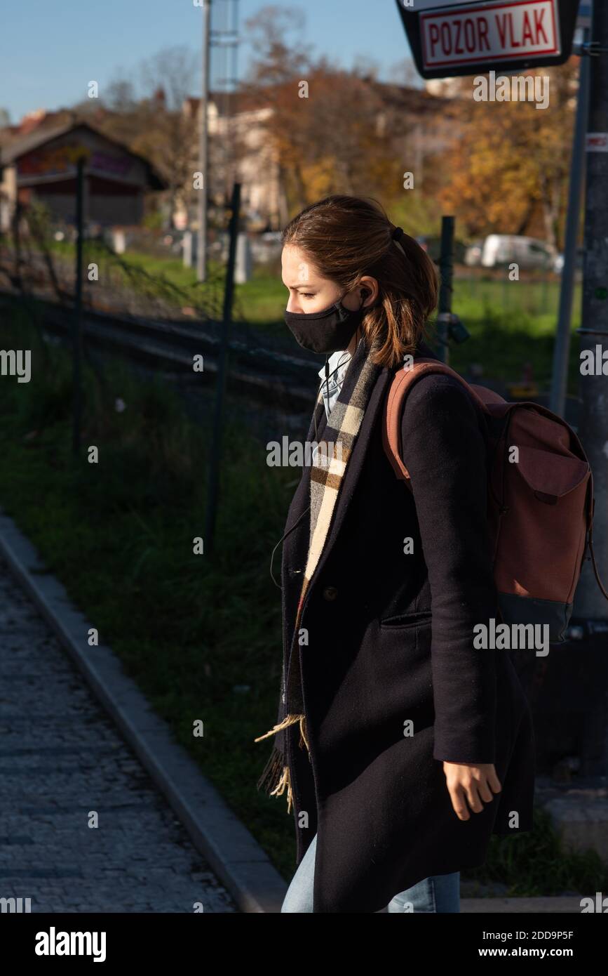 11-22-2020. Prague, Czech Republic. People during quarantine period due to coronavirus (COVID-19) at Hradcanska metro stop in Prague 6. Young woman wa Stock Photo
