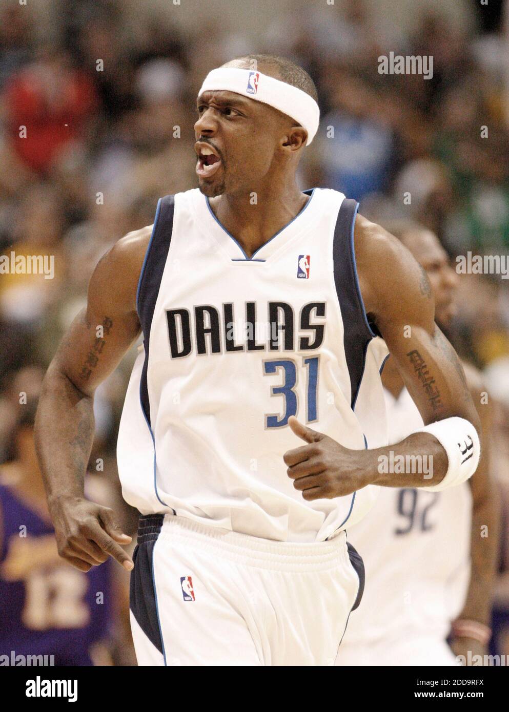 Dallas Mavericks shooting guard Jason Terry shows his tattoo off to fans  during the Dallas Mavericks parade at the American Airlines Center.