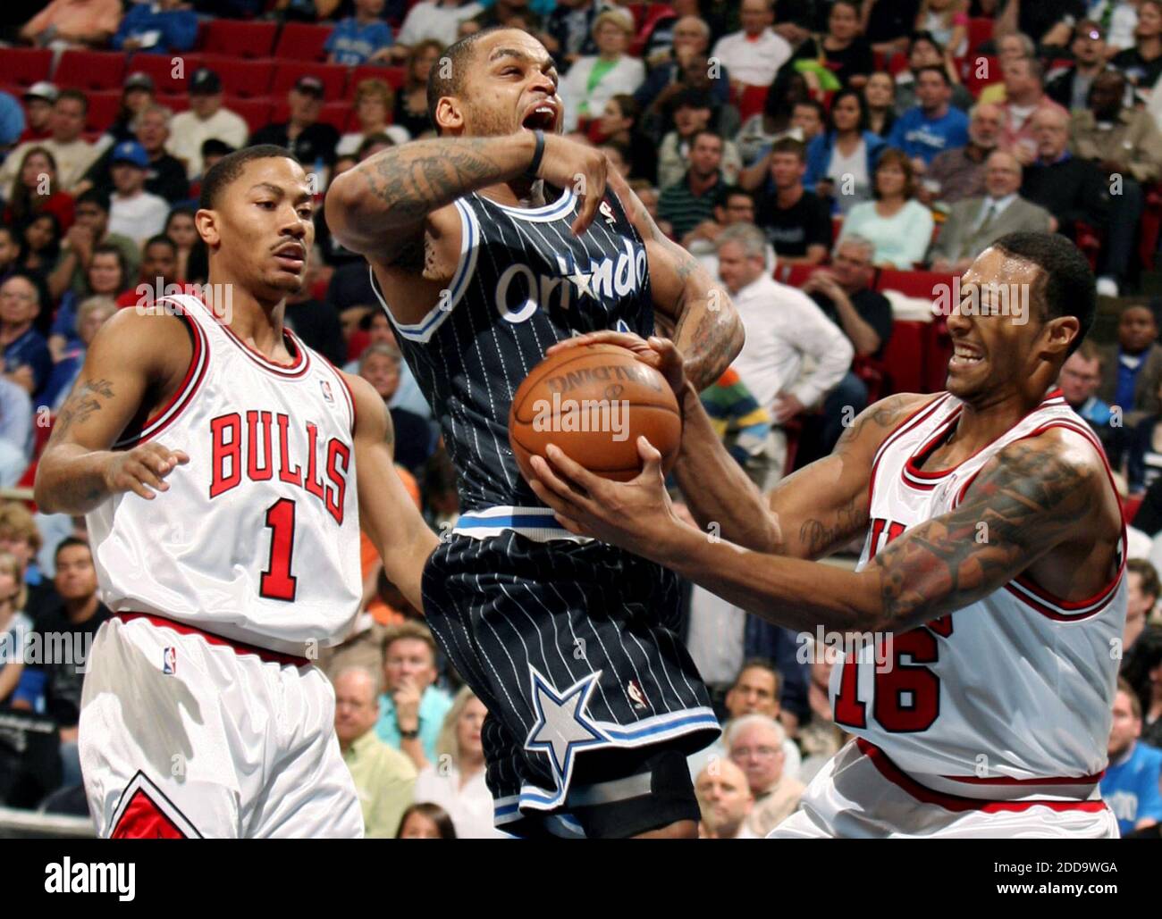 NO FILM, NO VIDEO, NO TV, NO DOCUMENTARY - Chicago Bulls guard Derrick Rose (1) and forward James Johnson (16) defends against Orlando Magic guard Jameer Nelson (14) during an NBA game at Amway Arena in Orlando, FL, USA on March 11, 2010. Photo by Stephen M. Dowell/Orlando Sentinel/MCT/Cameleon/ABACAPRESS.COM Stock Photo