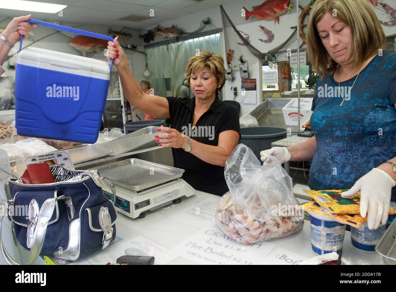 NO FILM, NO VIDEO, NO TV, NO DOCUMENTARY - Angela Harrington-Desporte, left, takes a cooler from customer Rose Merle Barrett (not pictured), as she and Kathy Juanica, right, get ready to fill it with fresh shrimp and other seafood at Desporte & Son's Seafood in Biloxi, Mississippi, USA on April 30 2010. Barrett, a regular at the seafood shop, came in to make sure she had fresh local seafood before oil spilling from a sunken rig in the Gulf reaches the Mississippi shore. Photo by Amanda McCoy/Biloxi Sun Herald/MCT/ABACAPRESS.COM Stock Photo