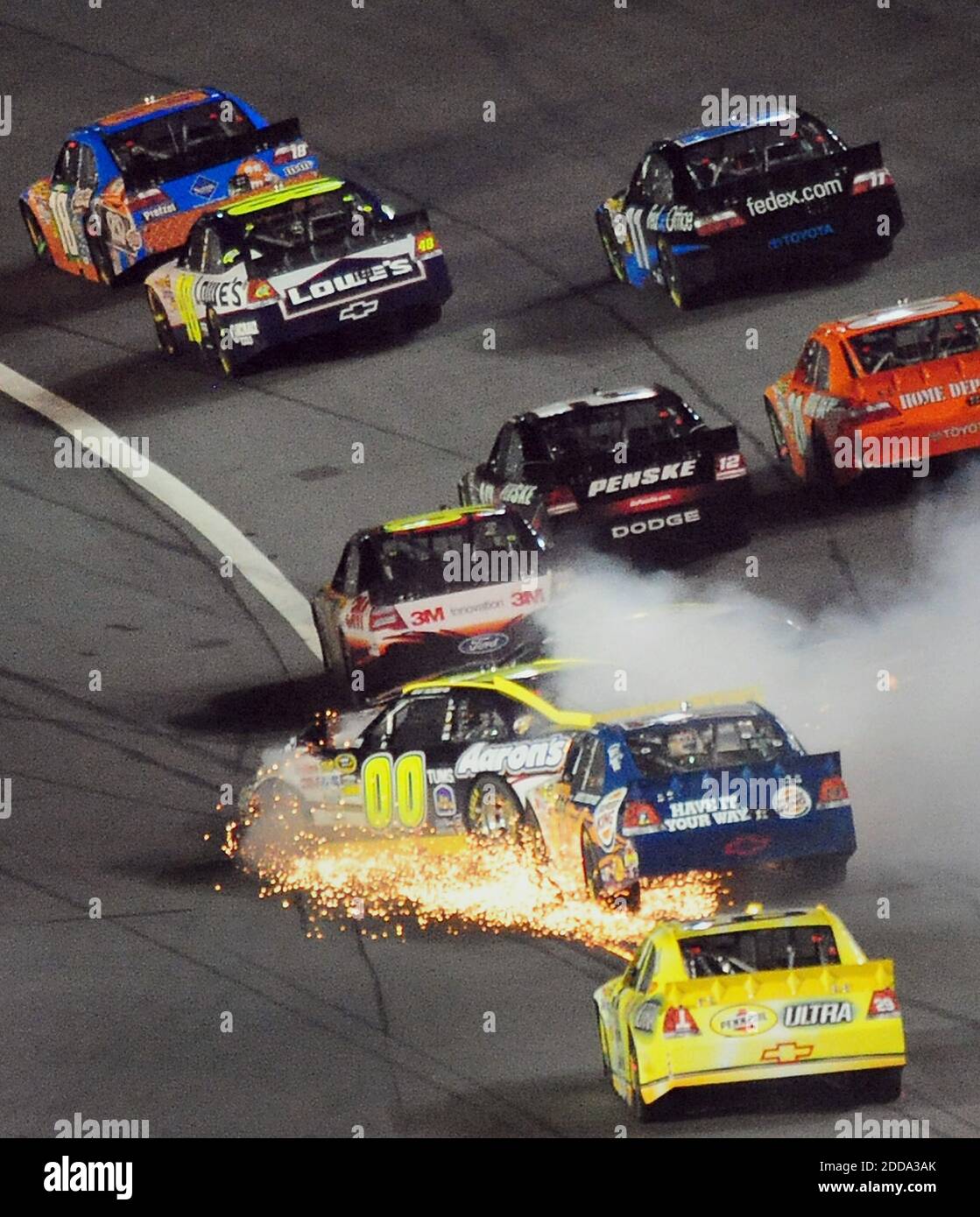 NO FILM, NO VIDEO, NO TV, NO DOCUMENTARY - NASCAR Sprint Cup Series driver David Reutimann (00) kicks up sparks as he and (obscured by smoke) Mark Martin (5) collide going into Turn 1 during the final segment of the NASCAR Sprint All-Star Race at Charlotte Motor Speedway in Charlotte, NC, USA on May 22, 2010. Below, David Reutimann (00) and Tony Stewart (14) collide. Phnoto by Jeff Siner/Charlotte Observer/MCT/Cameleon/ABACAPRESS.COM Stock Photo