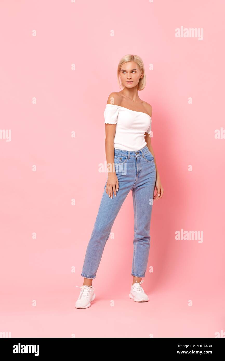 Woman wearing pink top jeans hi-res stock photography and images - Alamy