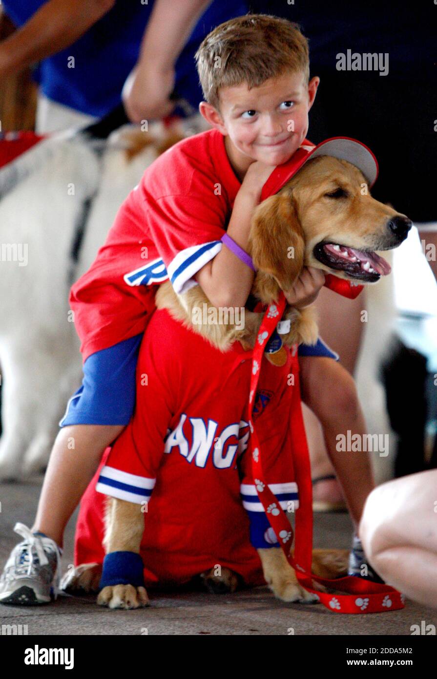 NO FILM, NO VIDEO, NO TV, NO DOCUMENTARY - Los Angeles Angels' young fan Jaret Liebbe holds his dog Telias and pose for a photo at dog night during the MLB Baseball match, Texas Rangers vs Los Angeles Angels at Rangers Ballpark in Arlington, USA on July 25, 2010. Photo by Richard W. Rodriguez/MCT/ABACAPRESS.COM Stock Photo