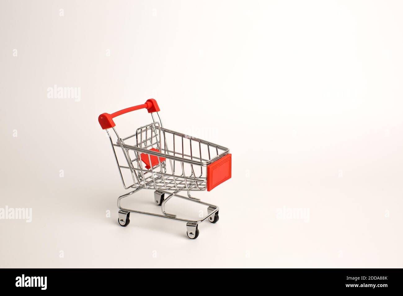 Shopping cart isolated on white background, toy shopping trolley Stock Photo