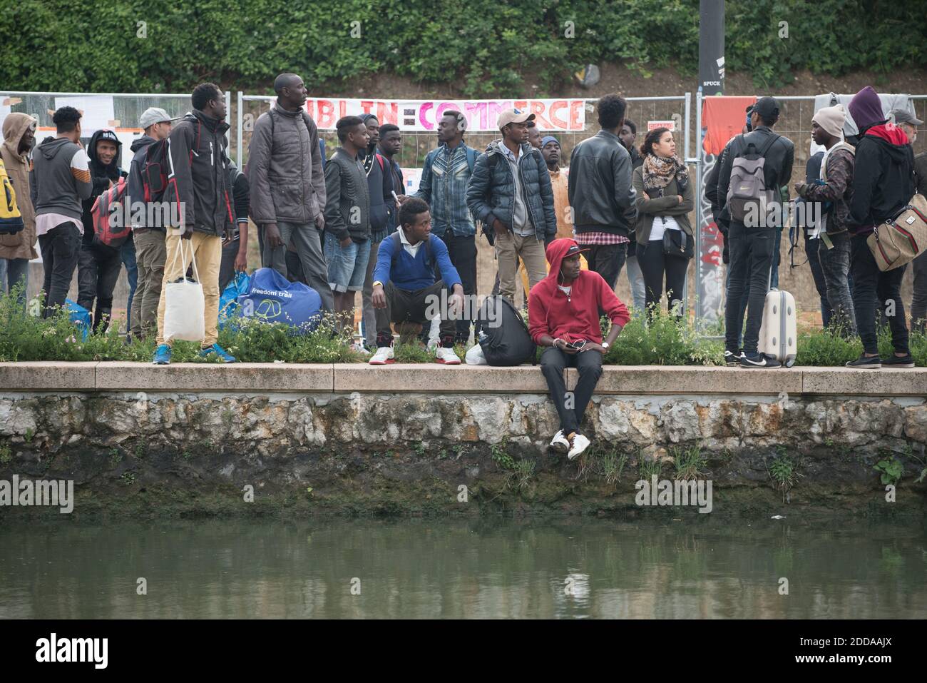 Migrants carry their belongings during the evacuation of the Millenaire makeshift camp along the Canal de Saint-Denis near Porte de la Villette, northern Paris, France, on May 30, 2018. More than a thousand migrants and refugees were evacuated on early May 30, 2018 from a makeshift camp that had been set up for several weeks along the Canal. Photo by Samuel Boivin/ABACAPRESS.COM Stock Photo